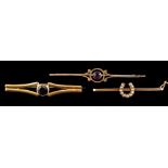 A 22 carat gold and sapphire brooch,: the circular cut sapphire in a collet setting,