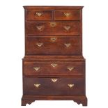 An 18th Century oak chest on chest:, the upper part with a moulded cornice,