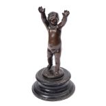 A late 19th century bronze figure of a putti: with outstretched raised arms,