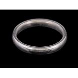 A platinum ring,: of plain polished form, stamped 950 with full London hallmarks, ring size J, 5.3g.