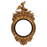 A Regency carved giltwood and gesso circular convex mirror:,