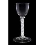 An English wine glass: the pointed funnel shaped bowl set on a double series opaque twist stem and