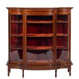 An Edwardian mahogany and inlaid serpentine-fronted display cabinet:, crossbanded in satinwood,