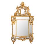 A French Regence carved giltwood marginal wall mirror:, with shaped domed cresting with mask,