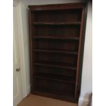 A Victorian mahogany library open bookcase:, with a moulded and rounded cornice,