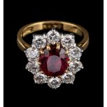 A ruby and diamond ring,: the central oval cut ruby, estimated to weigh 2.