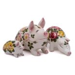 A group of three Exon Wemyss Ware pigs: modelled in seated and standing posture,