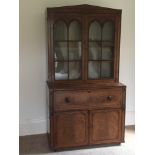 A George IV mahogany and ebony inlaid Gothic secretaire bookcase:,