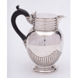 A Victorian silver hot water jug, maker Goldsmiths and Silversmiths Co Ltd, London, 1900: crested,