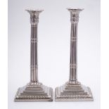 A pair of plated candlesticks: the sconces with palmette decoration,