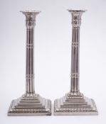 A pair of plated candlesticks: the sconces with palmette decoration,