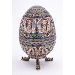 A late 20th century silver gilt and champlevé enamel Easter egg in the Imperial Russian style:
