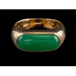 A green hardstone ring:, the oblong polished green hardstone, in a collet setting, stamped 585,