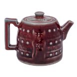 A Chinese copper red glazed teapot and cover: of circular squat form,