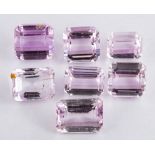 Seven unset kunzites,: the rectangular cut kunzites, approximately 133.00 carats total.