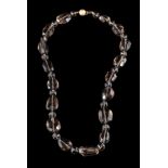 A smoky quartz necklace,: the faceted smoky quartz beads to a textured ball shaped clasp,