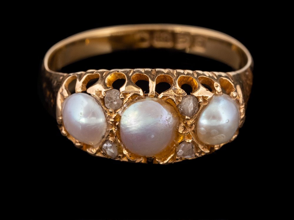 An Edwardian 18 carat gold pearl and diamond ring,