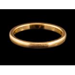 A 22 carat gold ring,: the plain polished band, stamped 22 with full Birmingham hallmarks for 1932,