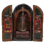 A papier mâché and polychrome decorated triptych: possibly South American, of arched outline,