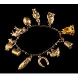 A charm bracelet,: with various charms, including a cat, a duck, a donkey, a shoe, and others,