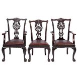 A set of four carved stained beech dining chairs in the Chippendale taste,