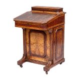 A Victorian walnut, amboyna, banded and inlaid Davenport:, bordered with boxwood and ebony lines,