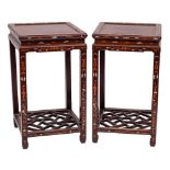 A pair of Chinese hardwood and marquetry square urn stands:, decorated with dragons, lion dogs,