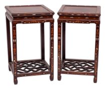 A pair of Chinese hardwood and marquetry square urn stands:, decorated with dragons, lion dogs,
