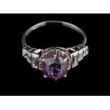 A platinum purple sapphire and diamond ring,: the circular cut purple sapphire stated to weigh 5.