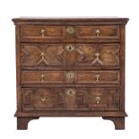A 17th Century oak rectangular chest:, the top with a moulded edge,