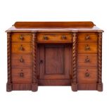 A Victorian mahogany kneehole desk:, of breakfront outline,