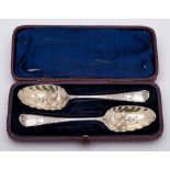 A pair of George III silver and later decorated berry spoons, maker Thomas Dene, London,