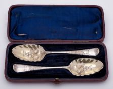 A pair of George III silver and later decorated berry spoons, maker Thomas Dene, London,