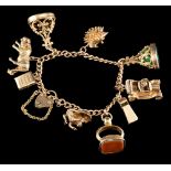 A 9 carat gold charm bracelet,: the curb link chain suspending various charms, including: a tiger,