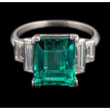 An emerald and diamond ring,: the rectangular cut emerald, stated to weigh 4.