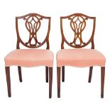 A pair of George III mahogany dining chairs:, in the Hepplewhite taste,