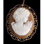 A 9 carat gold and shell cameo,: the oval shell cameo carved with a lady's profile,