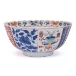 A Chinese verte-imari chrysanthemum moulded bowl: with lobed sides and scalloped rim,