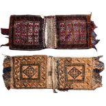 An Afghan Belouch saddle bag:, the shaded brick red fields with lozenge panels,