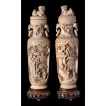 A pair of Chinese carved ivory vases with covers: of ovoid form with covers surmounted by temple