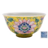 A Chinese yellow-ground famille rose 'peony' bowl: finely enamelled with three peony flowers