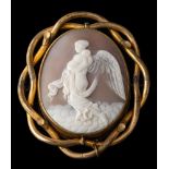 A shell cameo brooch,: the oval shell cameo carved with Nyx, collet set with an openwork surround,