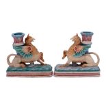 A pair of Royal Worcester majolica Griffin candlesticks: each winged griffin supporting a