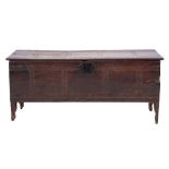 A 17th Century oak rectangular coffer:, of plank construction with a channel moulded hinged top,
