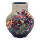 A Moorcroft pottery vase: of oviform with raised neck tubelined in the Spring Flowers pattern in