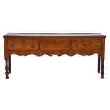 An 18th Century oak rectangular dresser base:, the top with a moulded edge,