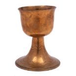 An Arts and Crafts influence gilt brass goblet: the plain bowl raised on an inverted flared