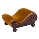 A Victorian yew-wood footstool of scroll outline:, upholstered in dralon fabric on ball-shaped feet,