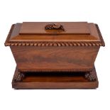 An early Victorian carved mahogany cellarette:, of sarcophagus shape,