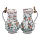 A matched pair of Chinese famille verte jugs and covers: of baluster form with Dutch gilt-metal
